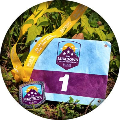 Race medal and bib for Meadows Virtual Marathon